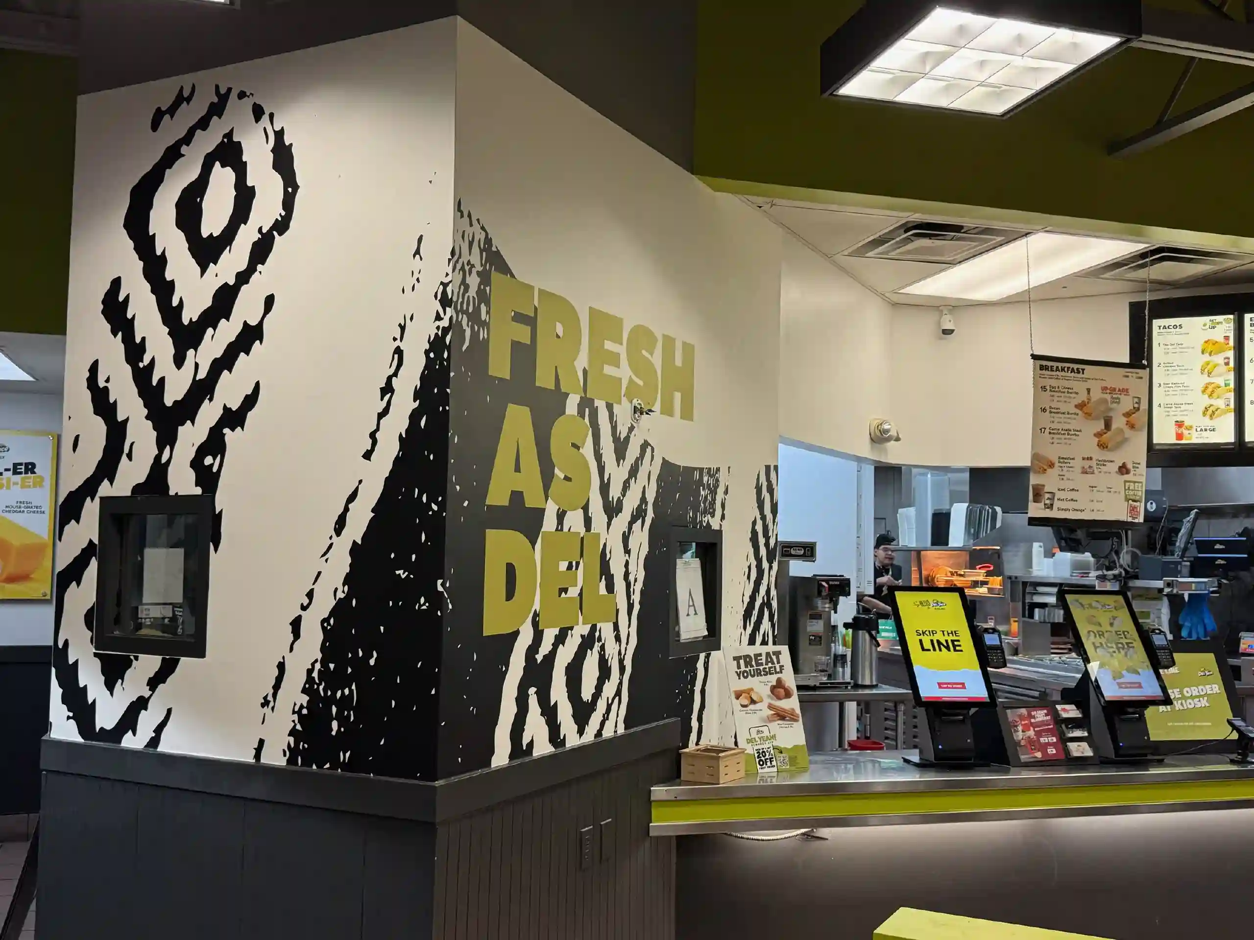 Commercial interior with dark patterned wallpaper and seating
